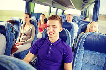 Image showing happy young man sitting in travel bus or train