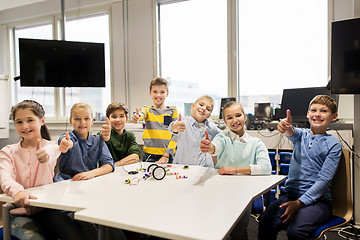 Image showing happy children building robots at robotics school