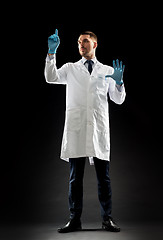 Image showing doctor or scientist in lab coat and medical gloves