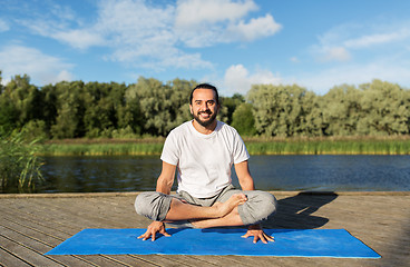 Image showing man making yoga in scale pose outdoors