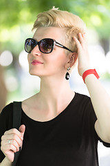 Image showing young woman with short blond hair and sunglasses