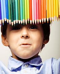 Image showing little cute boy with color pencils close up smiling, education face colored