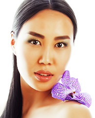 Image showing young pretty asian woman with flower orchid close up isolated sp