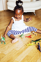 Image showing little cute african american girl playing with animal toys at ho