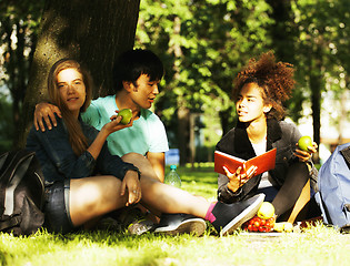 Image showing cute group of teenages at the building of university with books 