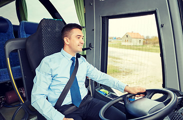 Image showing happy driver talking to microphone and driving bus