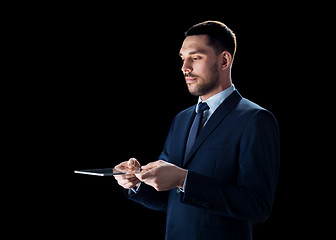 Image showing businessman in suit with transparent tablet pc