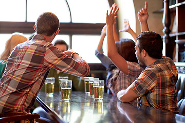 Image showing football fans or friends with beer at sport bar