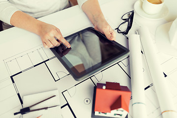 Image showing close up of hand with blueprint and tablet pc