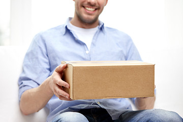 Image showing happy man with cardboard box or parcels at home