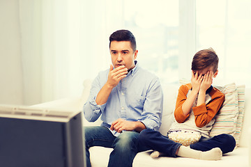 Image showing father and son watching horror movie on tv at home