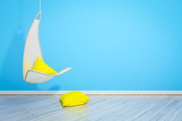 Image showing hanging armchair with yellow pillows