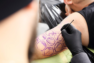 Image showing Creating a tattoo in a tattoo parlor. Stages of creating a tattoo.