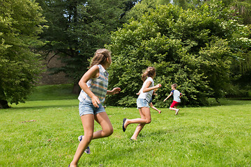 Image showing group of happy kids or friends playing outdoors