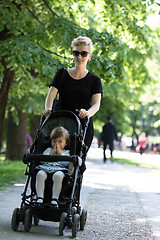 Image showing mother pushed her baby daughter in a stroller