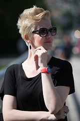 Image showing young woman with short blond hair and sunglasses