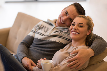 Image showing Young couple  in front of fireplace