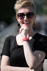 Image showing young woman with short blond hair and sunglasses