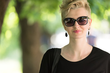 Image showing young woman with short blond hair and sunglasses