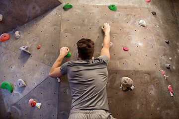 Image showing young man exercising at indoor climbing gym wall