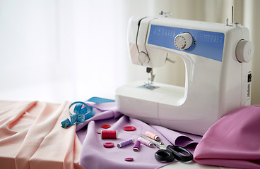 Image showing sewing machine, scissors, buttons and fabric