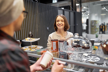 Image showing woman and man or barman with coffee cup at cafe