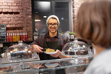 Image showing man or barman with cake serving customer at cafe