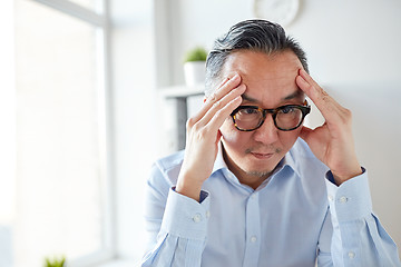 Image showing anxious businessman in eyeglasses at office