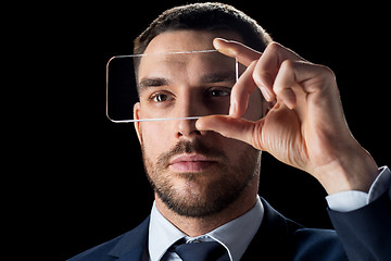 Image showing businessman with transparent smartphone