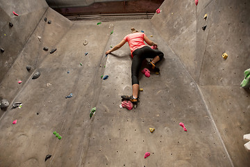 Image showing young woman exercising at indoor climbing gym