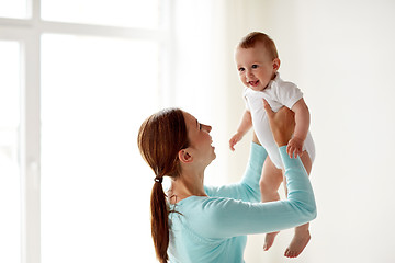 Image showing happy young mother with little baby at home