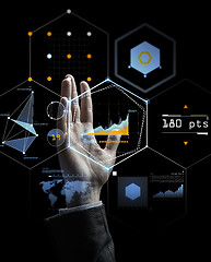 Image showing businessman hand with virtual charts over black