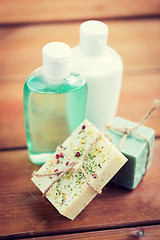 Image showing close up of handmade soap bars and lotions on wood