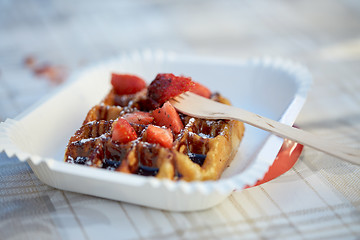 Image showing waffle with strawberry on paper plate and fork