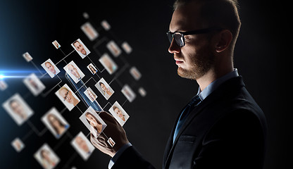 Image showing close up of businessman with tablet pc and icons