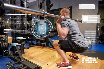 Image showing young man flexing muscles with bar in gym