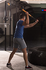 Image showing man workout with hammer and tractor tire