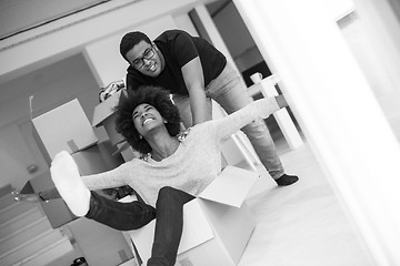 Image showing African American couple  playing with packing material