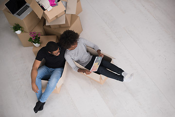 Image showing African American couple  playing with packing material