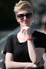 Image showing young woman with short blond hair and sunglasses