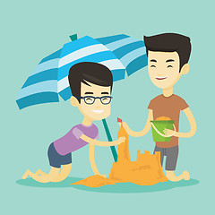 Image showing Two friends building sandcastle on beach.