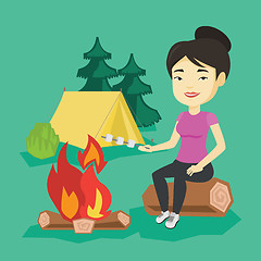 Image showing Woman roasting marshmallow over campfire.