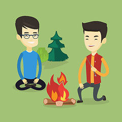 Image showing Two friends sitting around bonfire in camping.