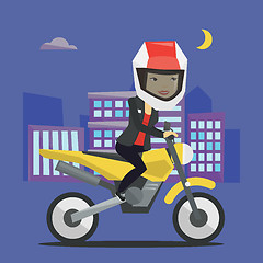 Image showing Woman riding motorcycle at night.