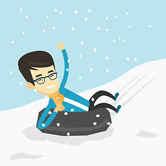 Image showing Man sledding on snow rubber tube in the mountains.