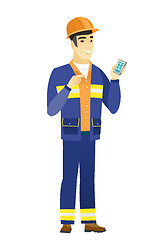 Image showing Asian builder holding a mobile phone.