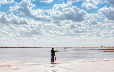 Image showing Man By The Lake Among Quartz Sand Under Beautiful Cloudy Sky