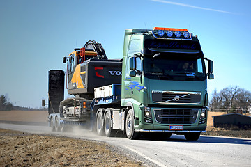 Image showing Green Volvo FH16 Transports Volvo CE Crawler Excavator