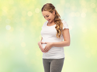 Image showing happy pregnant woman showing heart gesture