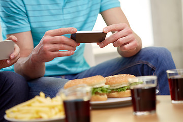 Image showing friends with smartphones taking picture of food